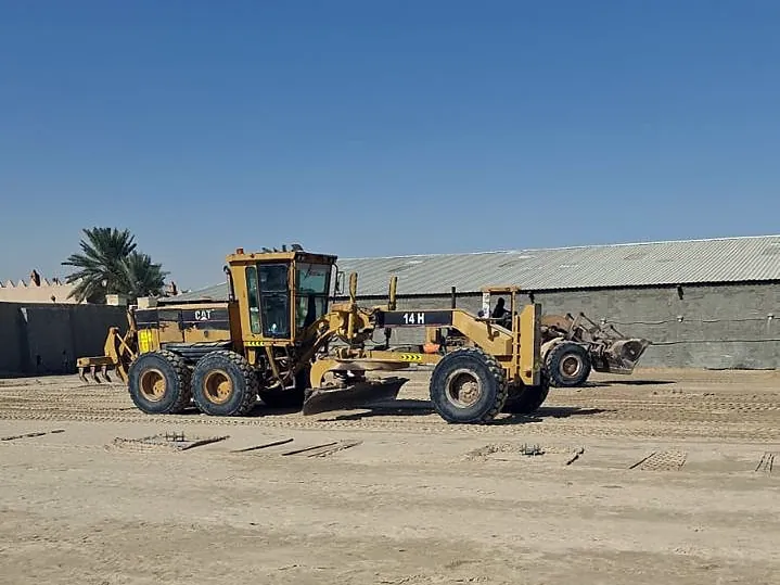 Motor grader levelling the site