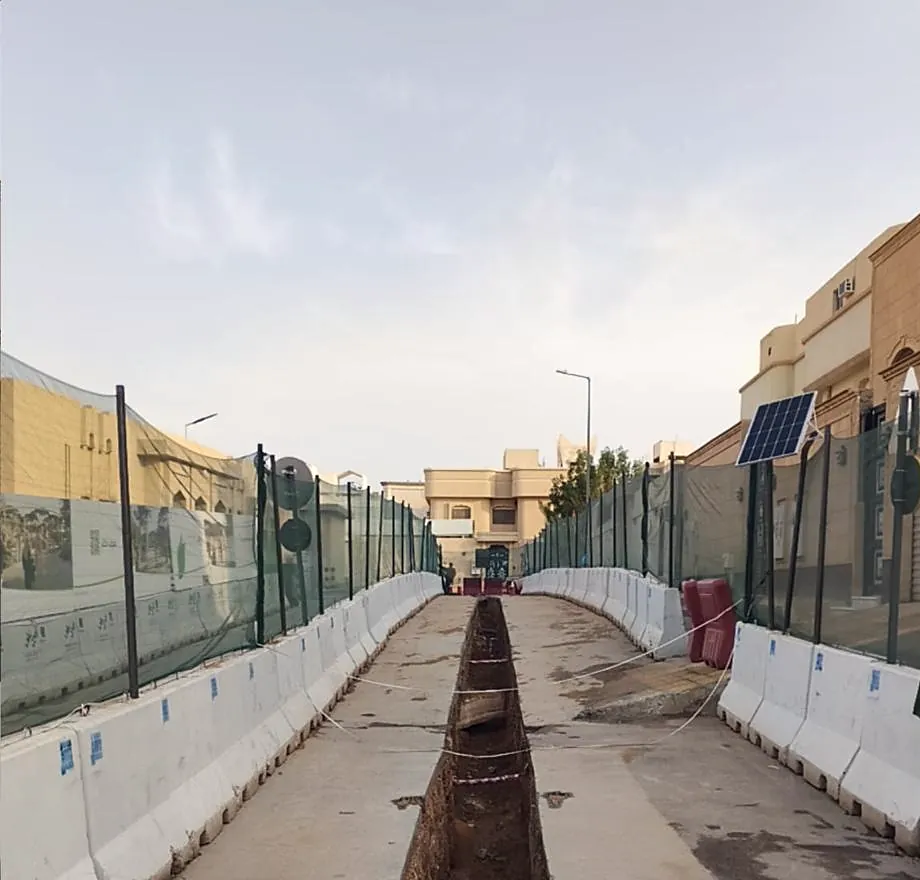 Excavated trench between safety barriers